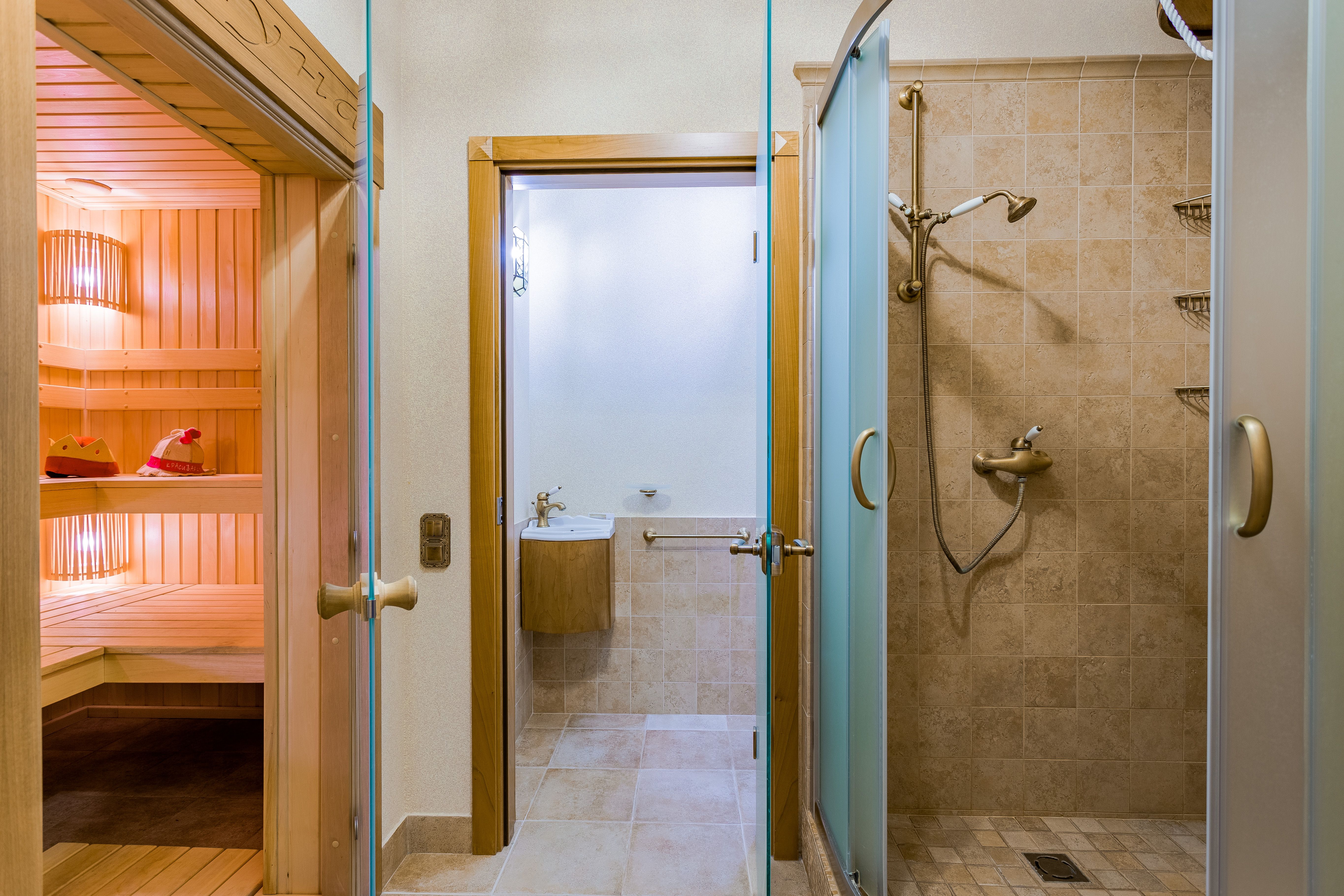 Quiet luxury spa interior with a sauna and modern shower facilities for private relaxation.